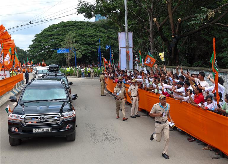 PM receives warm welcome by enthusiastic crowd during the Road Show on his arrival at Bengaluru, in Karnataka on August 10, 2025.
