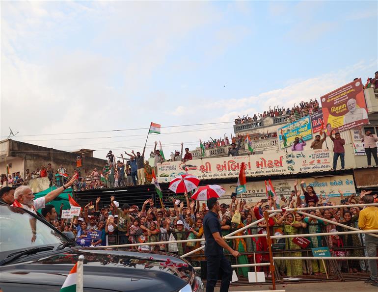 PM receives warm welcome by enthusiastic crowd during the Grand Road Show on his arrival at Ahmedabad, in Gujarat on August 25, 2025. 