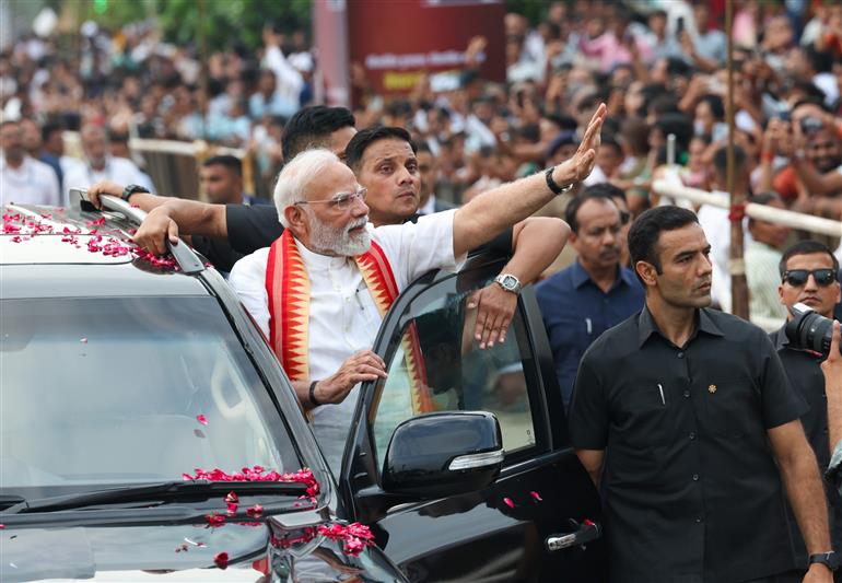 PM receives warm welcome by enthusiastic crowd during the Grand Road Show on his arrival at Ahmedabad, in Gujarat on August 25, 2025. 