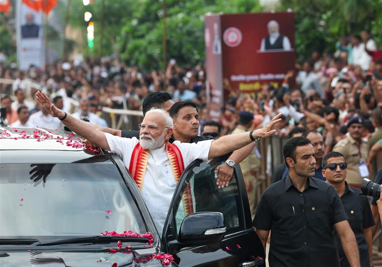 PM receives warm welcome by enthusiastic crowd during the Grand Road Show on his arrival at Ahmedabad, in Gujarat on August 25, 2025. 