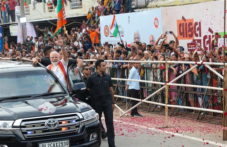 PM receives warm welcome by enthusiastic crowd during the Grand Road Show on his arrival at Ahmedabad, in Gujarat on August 25, 2025. 
