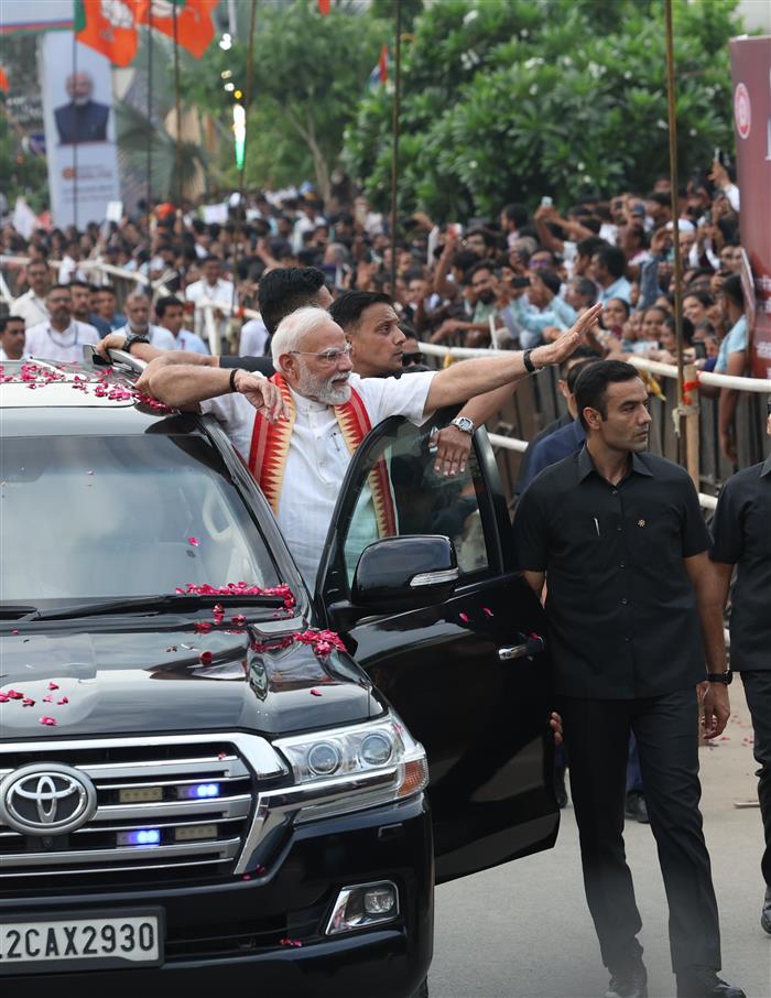 PM receives warm welcome by enthusiastic crowd during the Grand Road Show on his arrival at Ahmedabad, in Gujarat on August 25, 2025. 