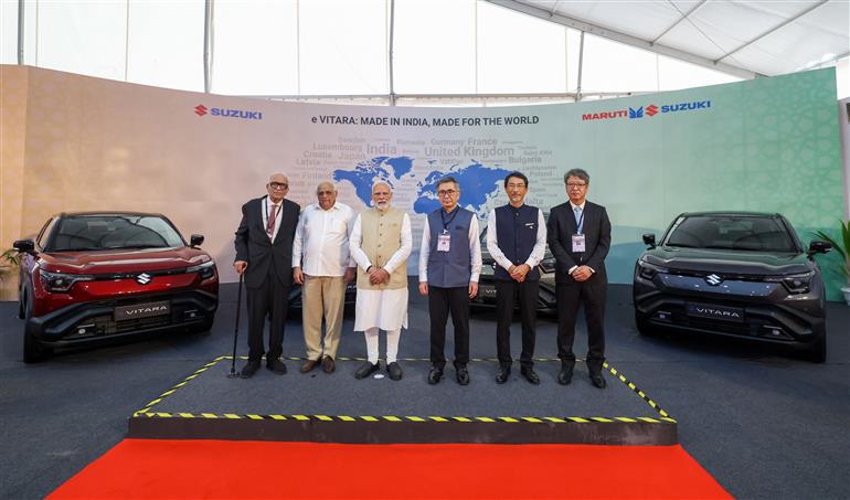 PM in a group photograph at the launch of green mobility initiatives at Hansalpur, in Gujarat on August 26, 2025.