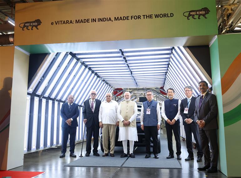 PM in a group photograph at the launch of green mobility initiatives at Hansalpur, in Gujarat on August 26, 2025.