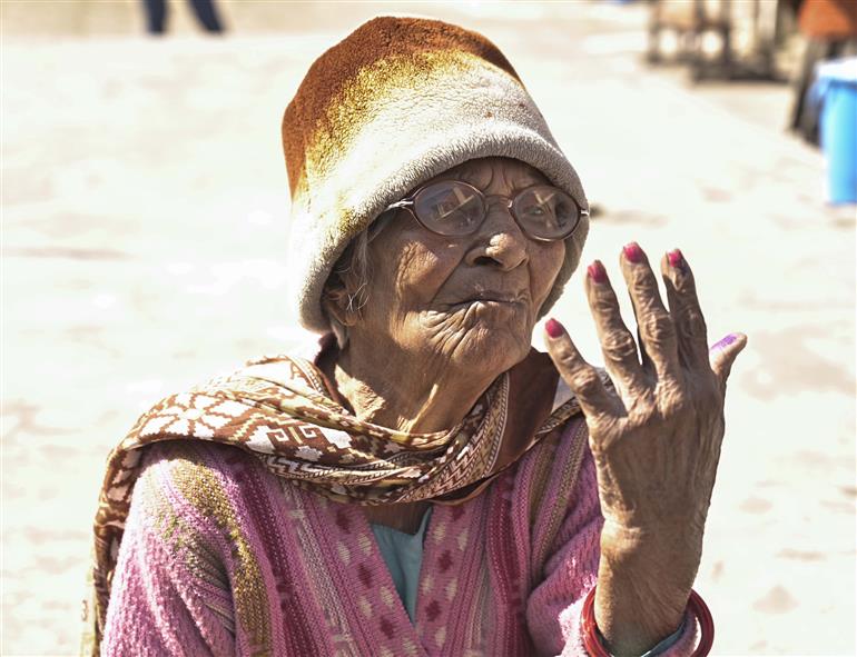 Old women voter showing mark of indelible ink after casting their vote at a polling booth during Delhi Assembly Election 2025 at Saint Michael primary school bhogal, Delhi on February 05, 2025.