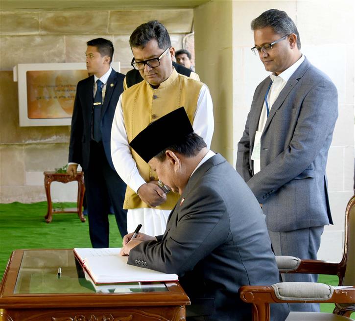 The President of Indonesia, Mr. Prabowo Subianto writing his remarks in the visitor book at Rajghat, in Delhi on January 25, 2025.