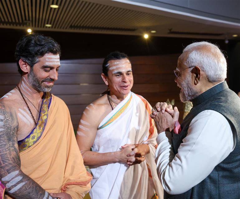 PM receives a cultural welcome by Acharya Jonas Masetti and group on his arrival at  hotel, in Brasília, in Brazil on July 07, 2025.
