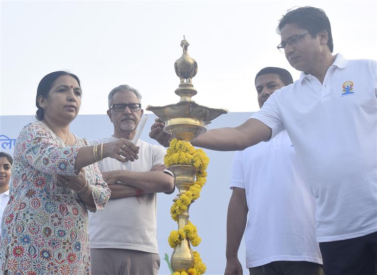 The Secretary, Department of Consumer Affairs, Ms. Nidhi Khare lighting the lamp during the 11th International Day of Yoga celebrations at Sunder Nursery, in New Delhi on June 21, 2025. The Secretary, Ministry of New and Renewable Energy (MNRE), Shri Santosh Kumar Sarangi and the Secretary, Department of Food and Public Distribution, Shri Sanjeev Chopra are also present.:AYUSH