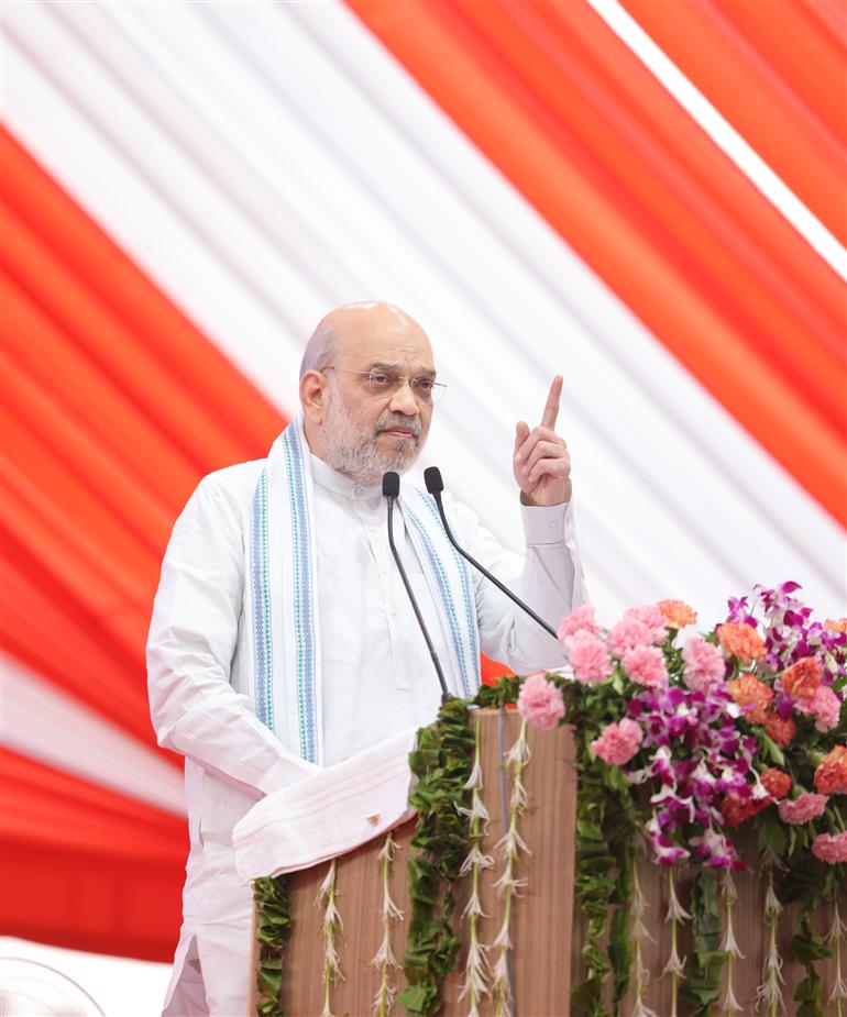 The Union Minister for Home Affairs and Cooperation, Shri Amit Shah addresses the benefit distribution program of the Postal Department at Gandhinagar, in Gujarat on May 17, 2025.