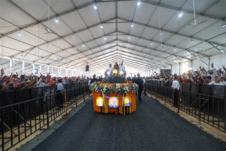 PM receives warm welcome by people during the inauguration and laying the foundation stone of development projects at Narmada, in Gujarat on November 15, 2025.