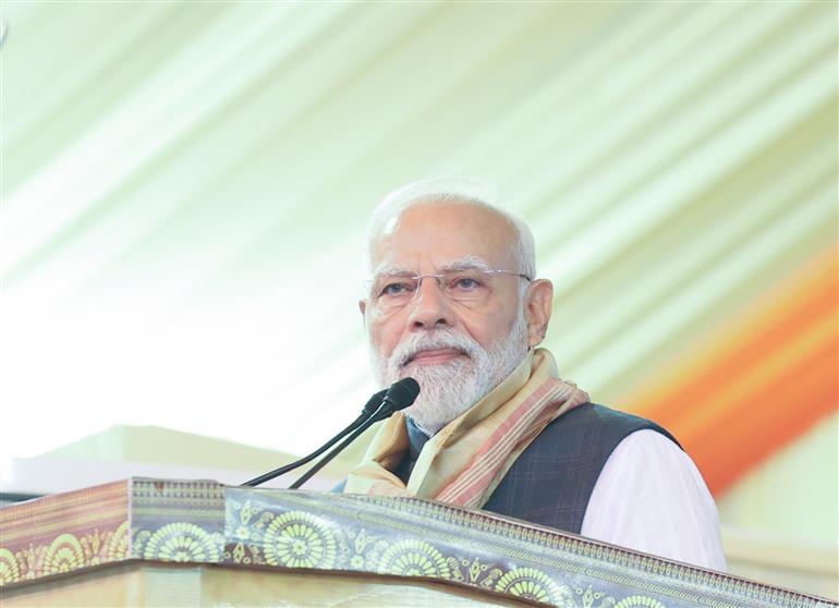 PM addressing the gathering at the inauguration and laying the foundation stone of multiple development projects at Darrang, in Assam on September 14, 2025.