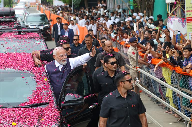 PM receives warm welcome by enthusiastic crowd during the Grand Road Show on his arrival at Bhavnagar, in Gujarat on September 20, 2025.