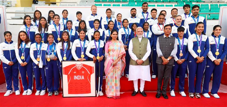 PM in a group photograph with the Indian Contingent for Asian Games 2026, in New Delhi on October 15, 2026.