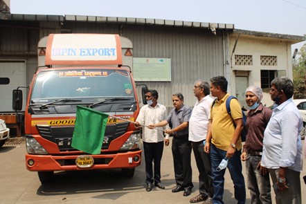 A group of people standing next to a truckDescription automatically generated with medium confidence