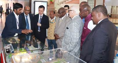 A group of men standing in front of a glass caseAI-generated content may be incorrect.