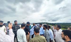A group of people standing on a roadAI-generated content may be incorrect.