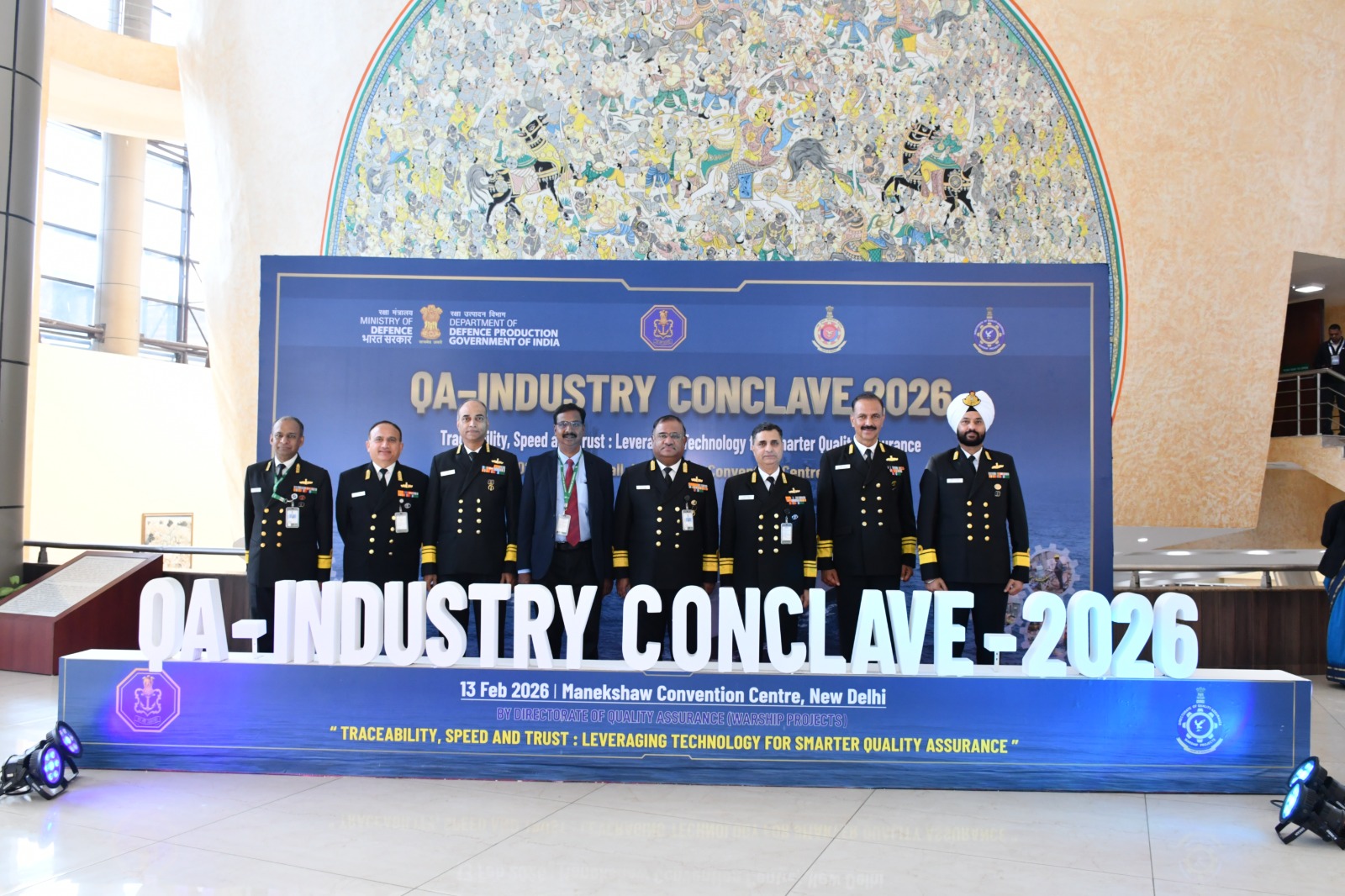 A group of men in military uniforms standing in front of a signDescription automatically generated