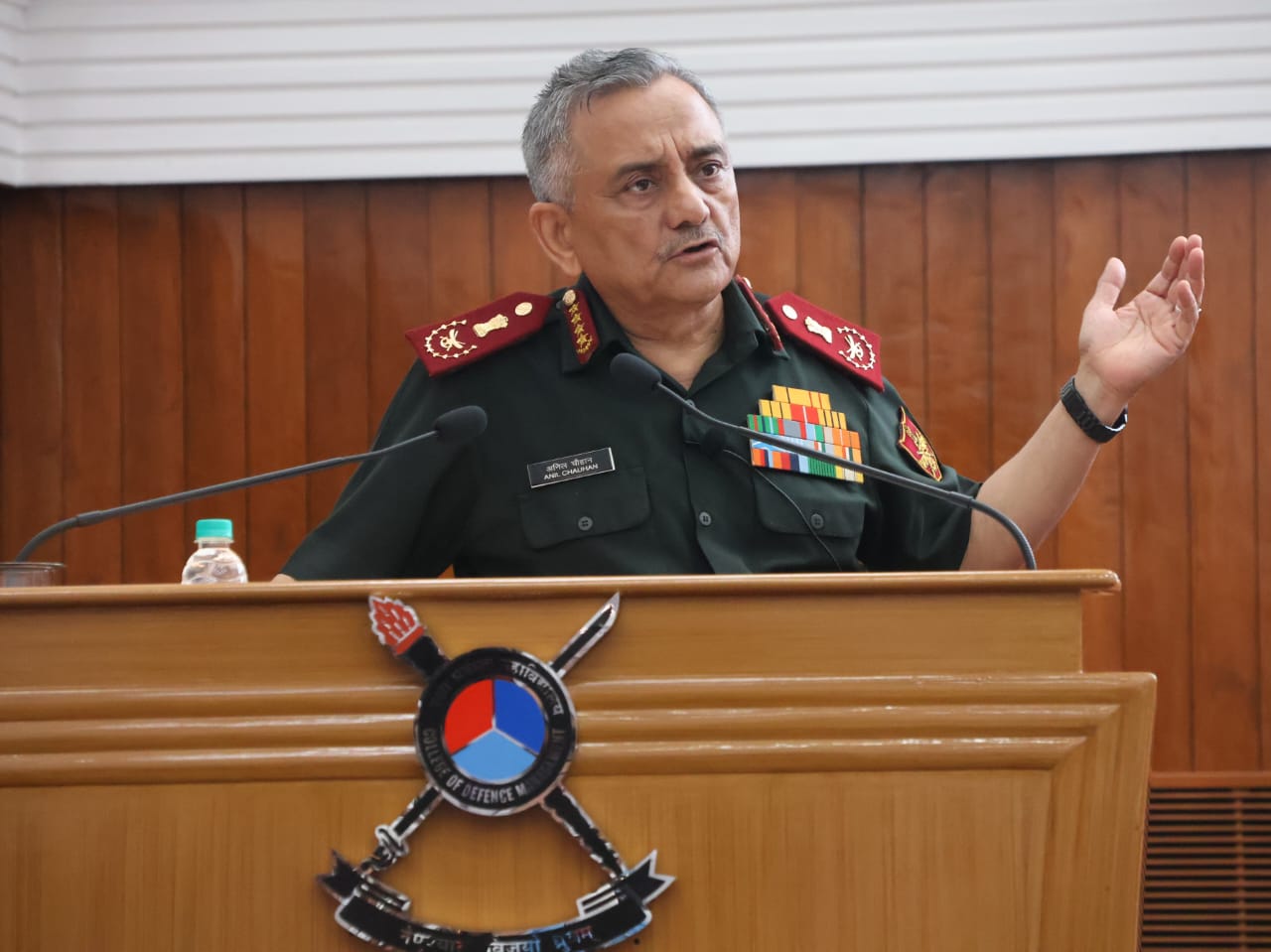 A person in uniform speaking at a podiumDescription automatically generated