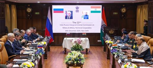 A room with a large screen and flowersDescription automatically generated