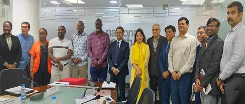 A group of people standing in a roomAI-generated content may be incorrect.