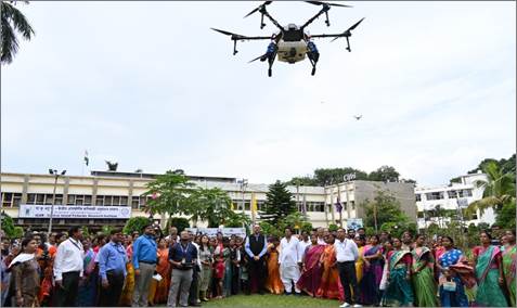 A drone flying over a group of peopleDescription automatically generated