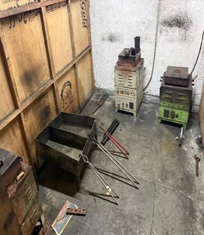 A metal box with tools on the floor