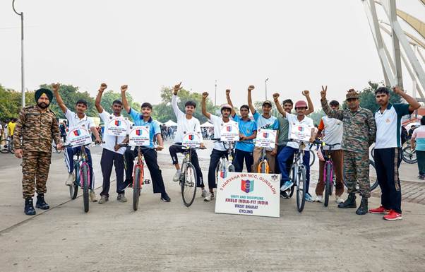 A group of people on bicycles with signsDescription automatically generated