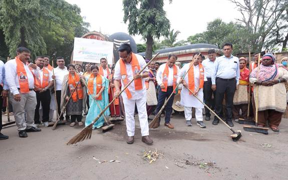 A group of people holding broomsAI-generated content may be incorrect.