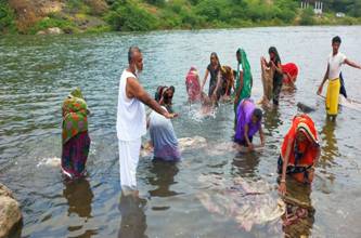 A group of people swimming in a body of waterDescription automatically generated