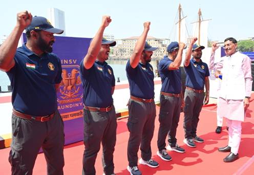 A group of men standing on a red carpetDescription automatically generated