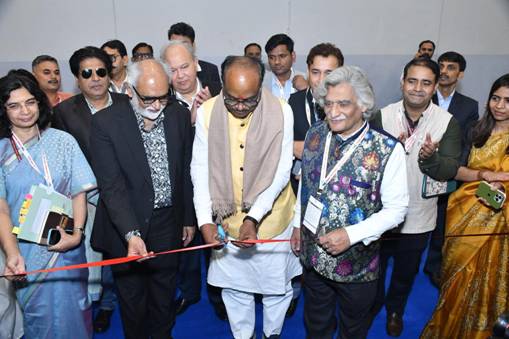 A group of people cutting a red ribbonAI-generated content may be incorrect.