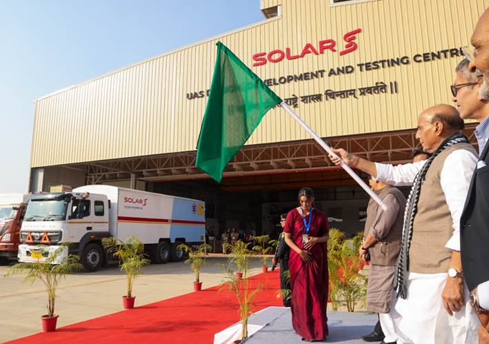 A person holding a green flagDescription automatically generated