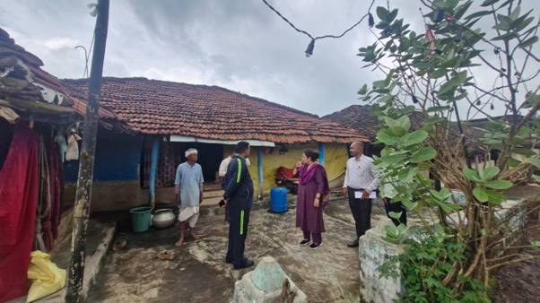 A group of people standing outside a houseAI-generated content may be incorrect.