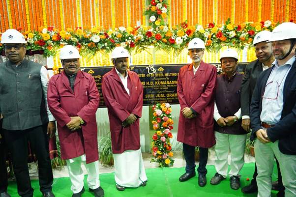 A group of men wearing white hard hats and red coatsAI-generated content may be incorrect.