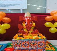 A statue of an elephant with a garland of flowersAI-generated content may be incorrect.