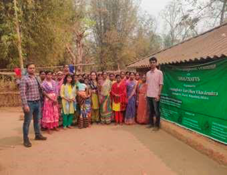 A group of people standing in front of a green tentDescription automatically generated with low confidence