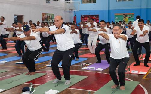 A group of people doing yogaDescription automatically generated