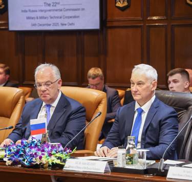 A group of men sitting at a tableDescription automatically generated