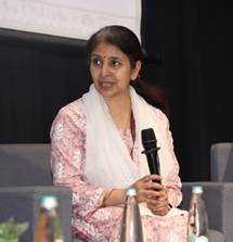 A person holding a microphone and a person sitting in a chairAI-generated content may be incorrect.