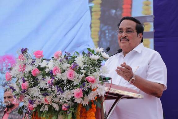 A person standing at a podium with a bunch of flowersAI-generated content may be incorrect.