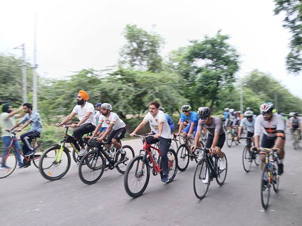 A group of people riding bicyclesDescription automatically generated