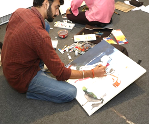 A person painting on the floorAI-generated content may be incorrect.