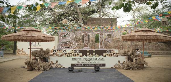 A stage with a sign and straw umbrellasAI-generated content may be incorrect.