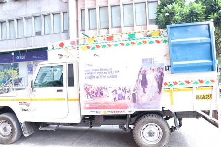 A white truck with a colorful sign on the sideDescription automatically generated