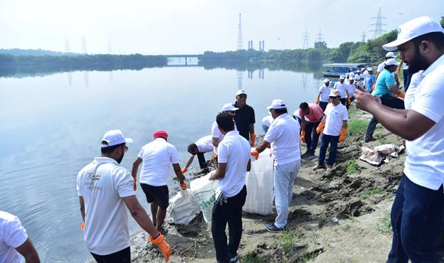 A group of people cleaning up the waterDescription automatically generated