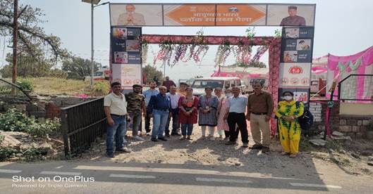 A group of people standing in front of a signDescription automatically generated with medium confidence