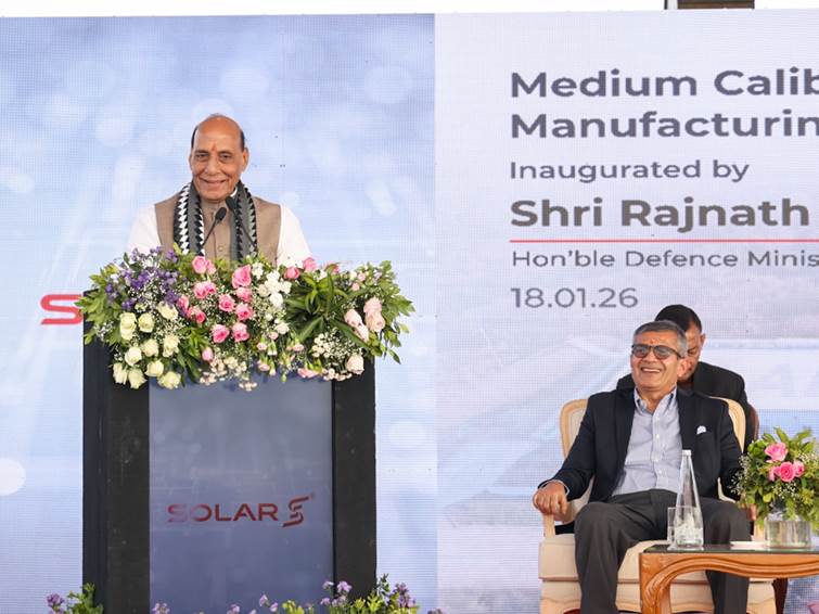 A person standing at a podium with a podium and a podium with flowersDescription automatically generated