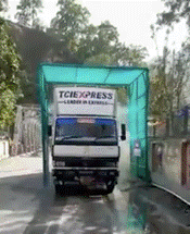 Description: A truck driving down a streetDescription automatically generated