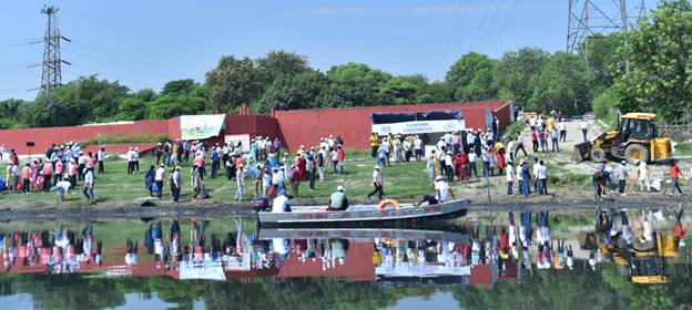 A group of people standing on the waterDescription automatically generated