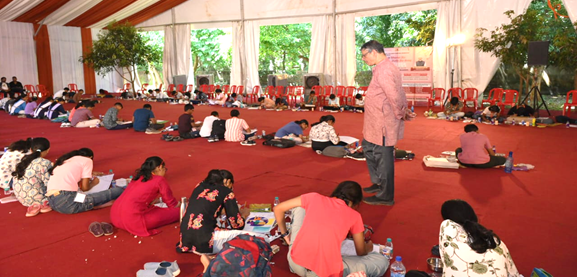 A group of people sitting on the floor in a tentAI-generated content may be incorrect.